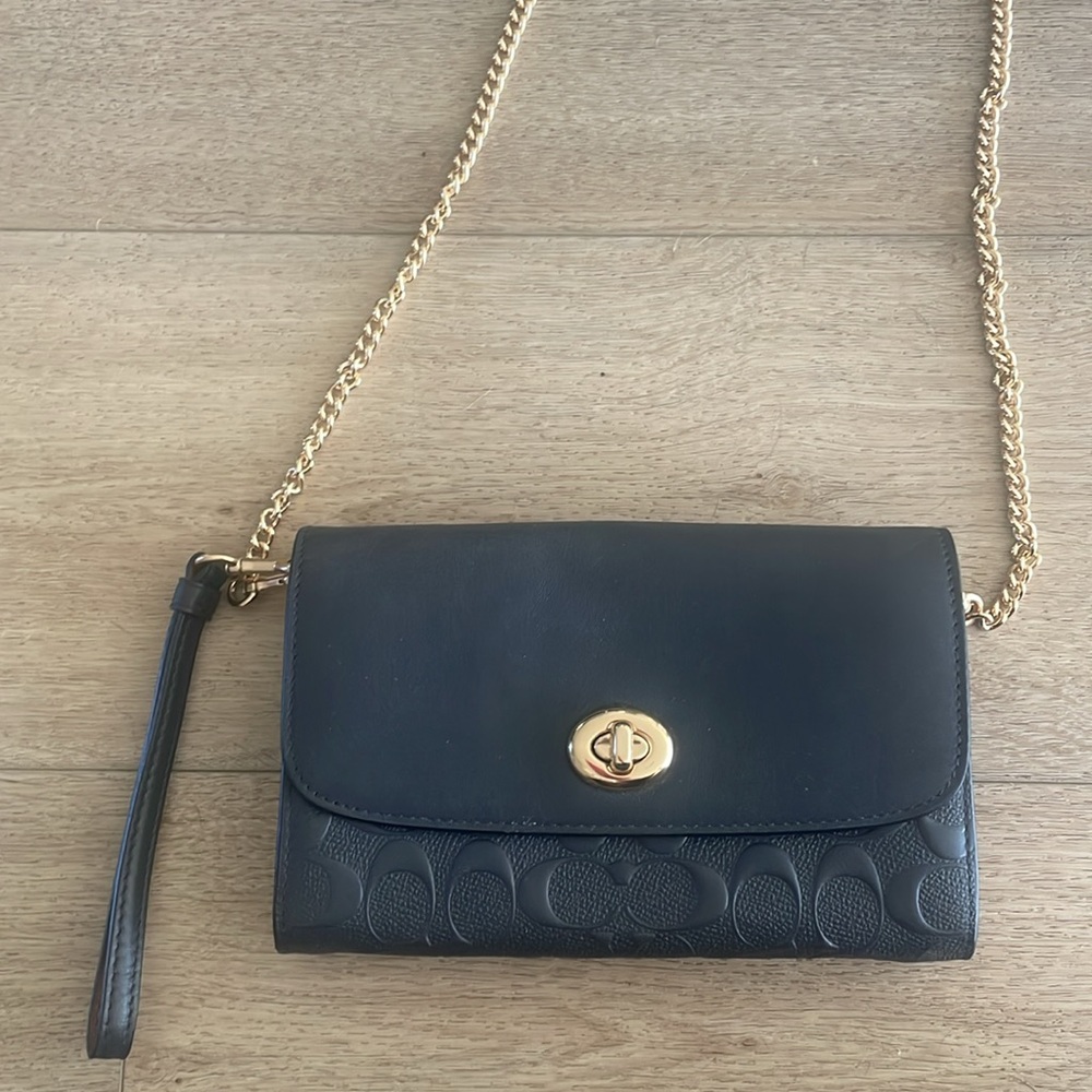 Coach wallet with chain strap and wrist strap.